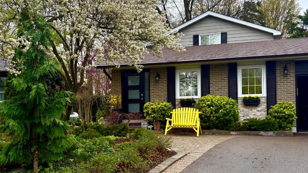 een gele stoel voor een huis bij Private Apartment Where Remote Work Meets Real Comfort in Oakville