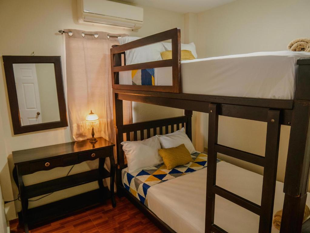 a bedroom with two bunk beds and a mirror at Amar&Yeah House in Salcoatitán