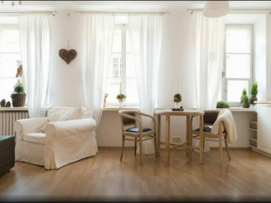 a living room with a table and a couch at Piwna Vintage Apartment in Warsaw