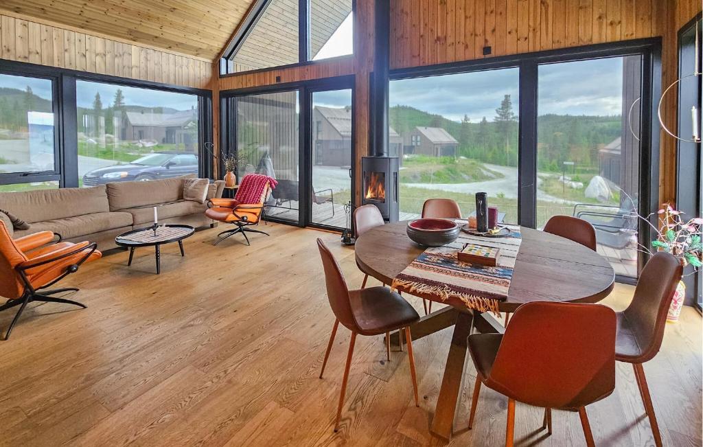 a living room with a wooden table and chairs at Stunning Home In Nesbyen With Wifi in Nesbyen