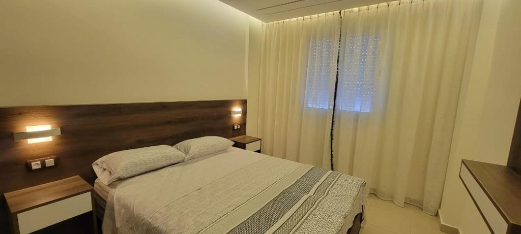 a bedroom with a large bed and a window at Precioso apartamento en el marjane in Tetouan