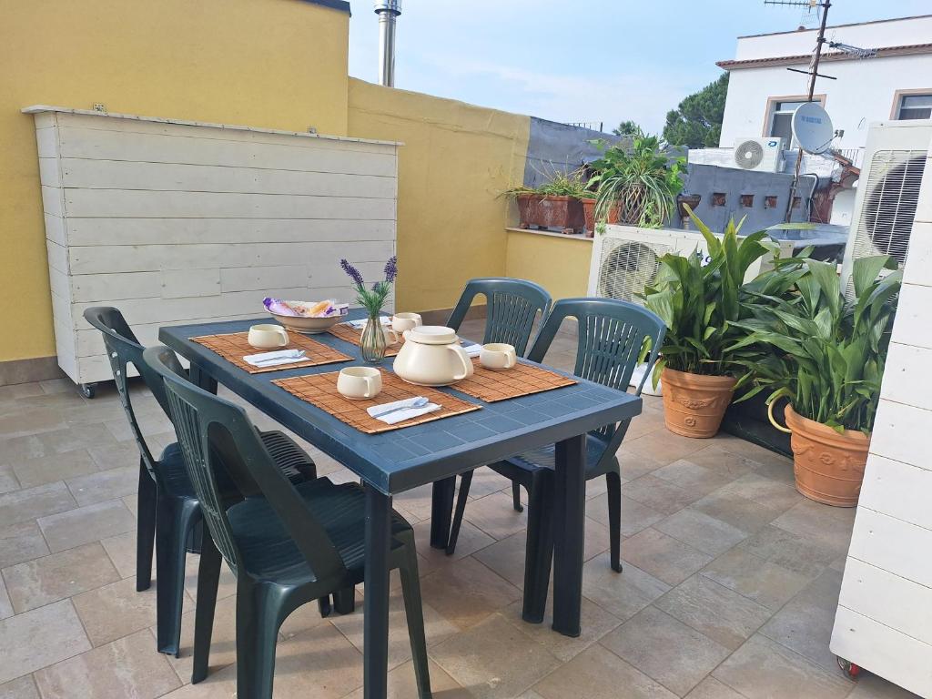 a blue table and chairs on a patio at Casa Helvius - Dimora in centro storico in Sant'Egidio del Monte Albino