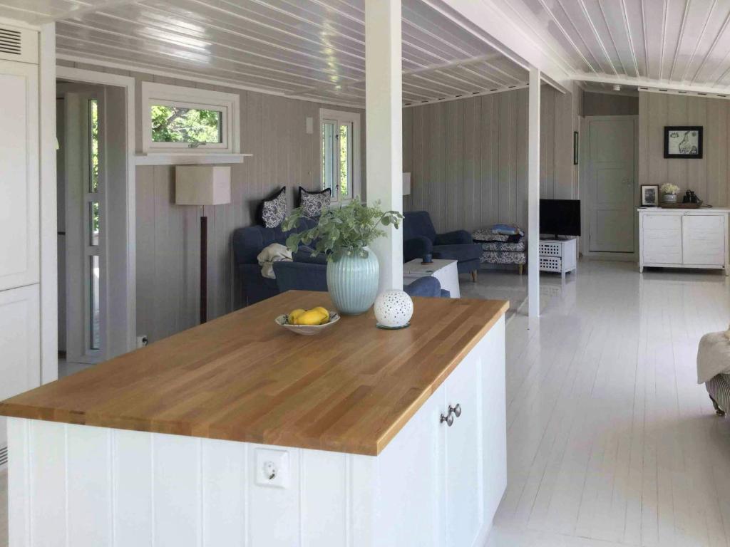 a kitchen with a island in a living room at Charming Holiday Home By Sea Near Stavern in Stavern
