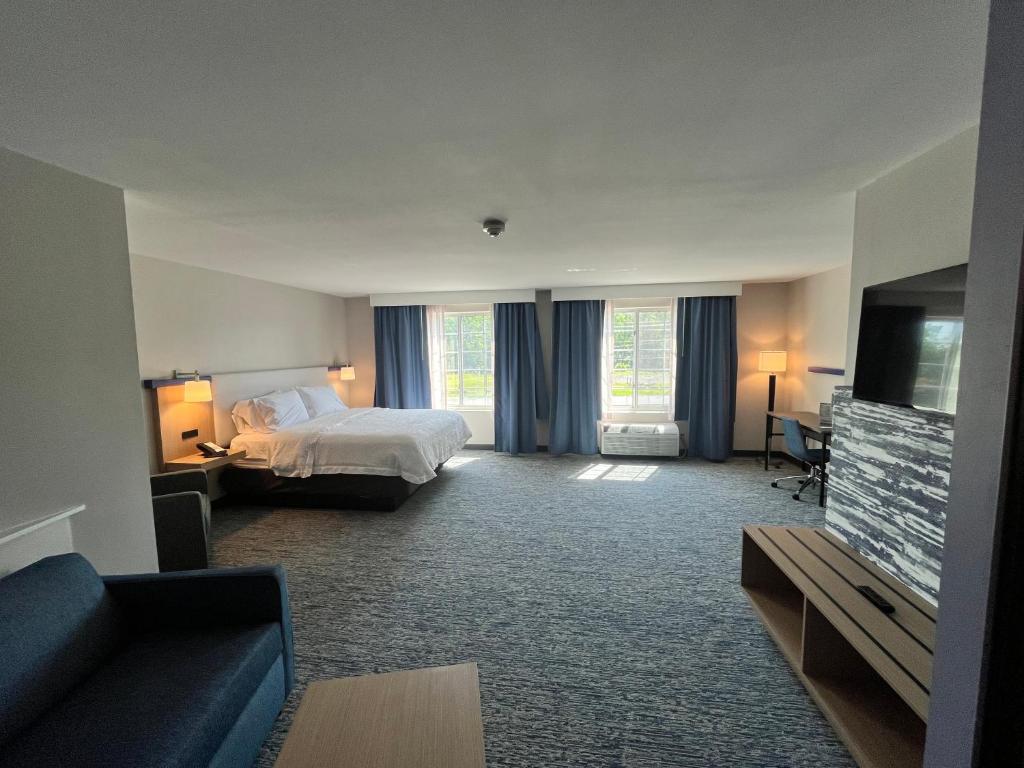 a hotel room with a bed and a flat screen tv at Garner Hotel Mahwah by IHG in Mahwah