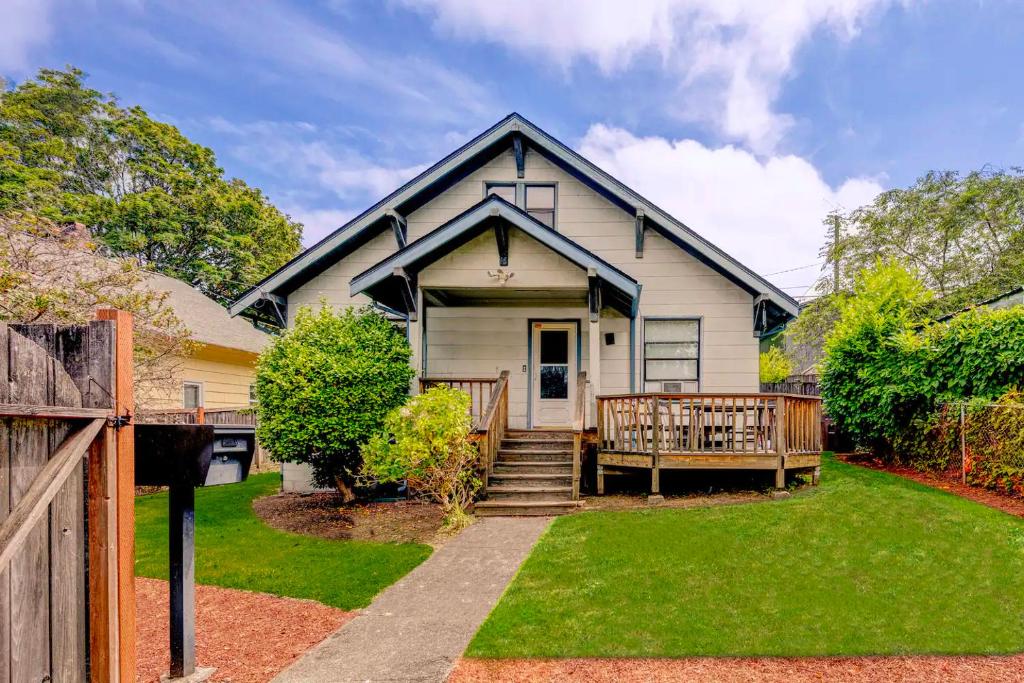 a white house with a porch and a fence at You Deserve the Best! in Tacoma