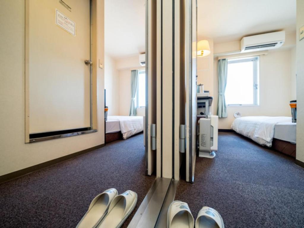 Postel nebo postele na pokoji v ubytování Super Hotel Matsusaka