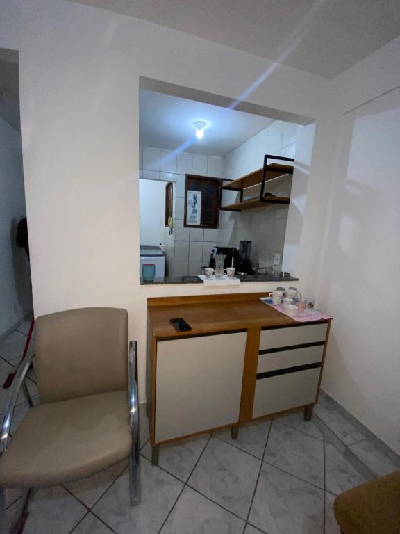 a kitchen with a desk and a chair in a room at casa km in Rio das Ostras