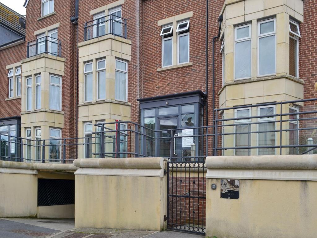 a brick building with a gate in front of it at Number 7 in Whitby