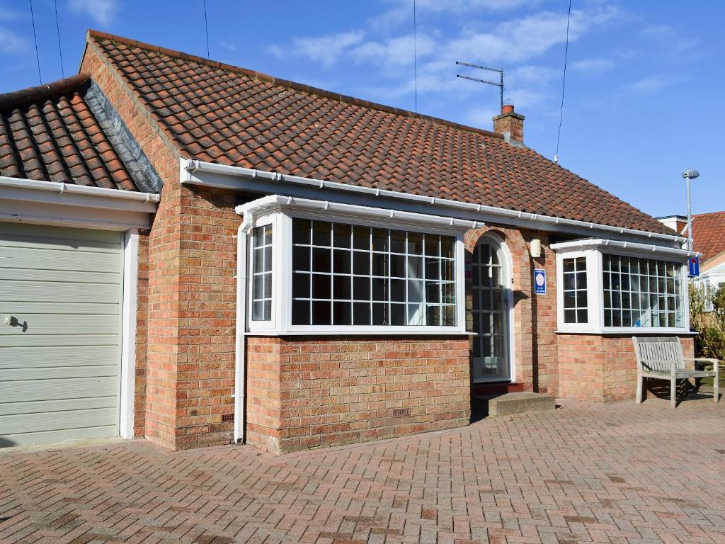 a brick house with a door and a garage at Oakwood in Bridlington