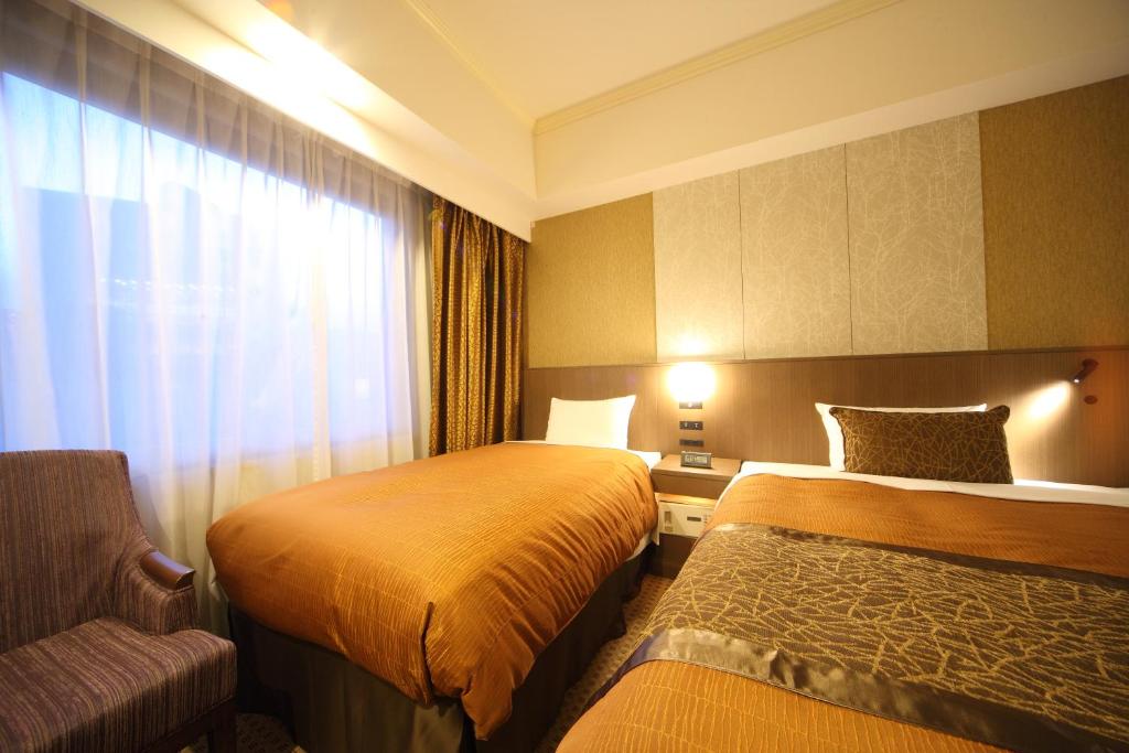 Postel nebo postele na pokoji v ubytování Hotel Metropolitan Nagano