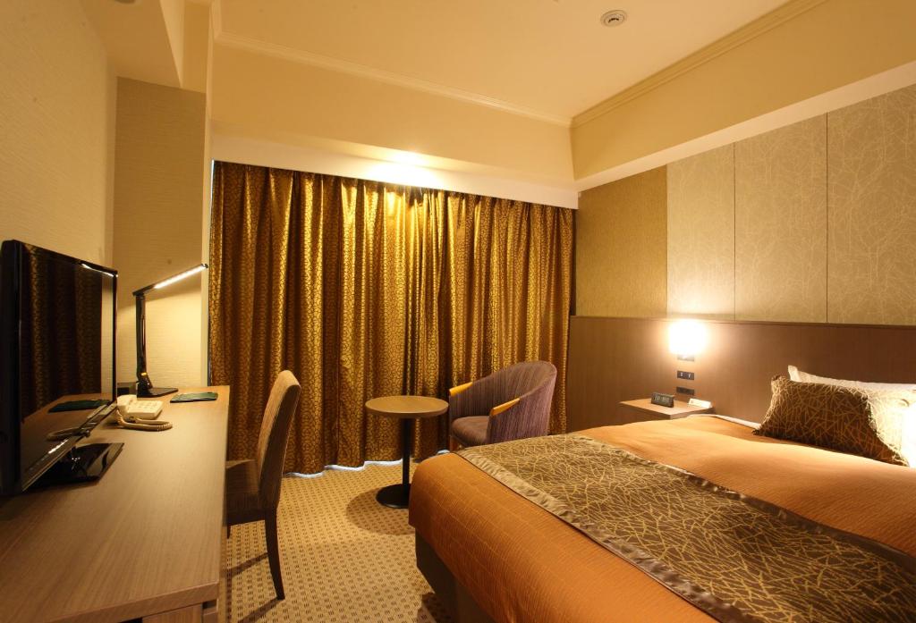 Postel nebo postele na pokoji v ubytování Hotel Metropolitan Nagano