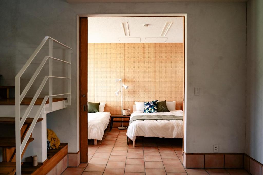 a bedroom with a bed and a staircase in a room at Lake Toya Retreat in Lake Toya
