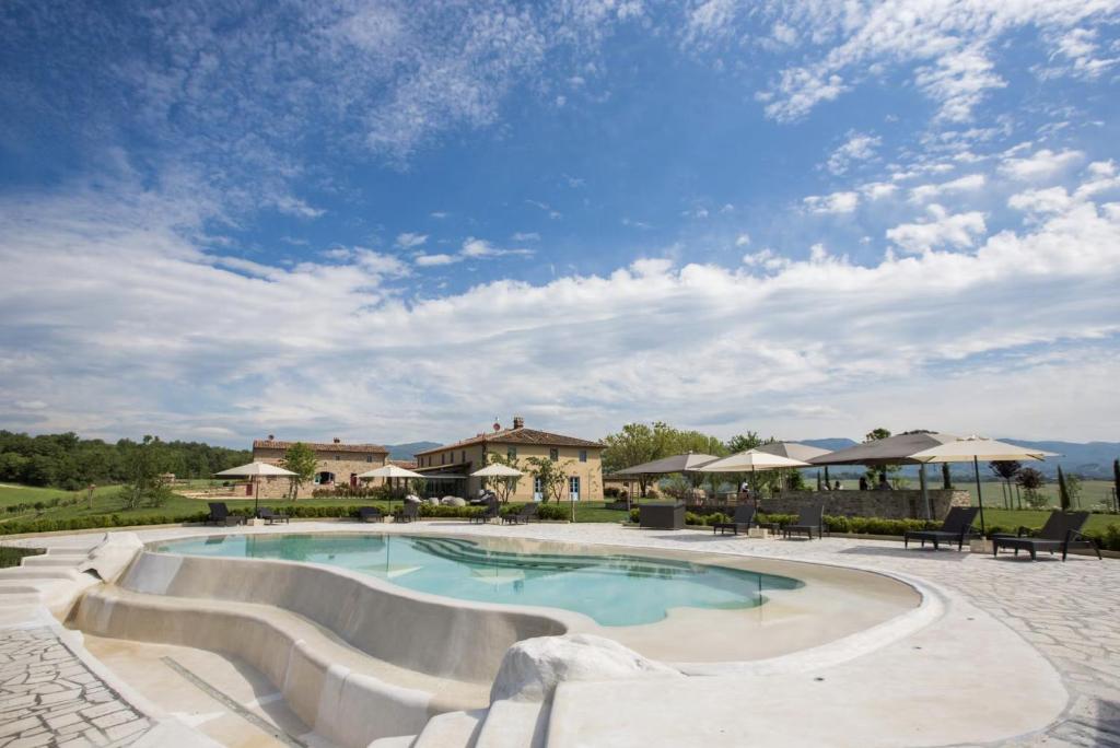 a swimming pool with ramps in a resort at Restored 18Th Century Borgo In Tuscan Countryside in Galliano