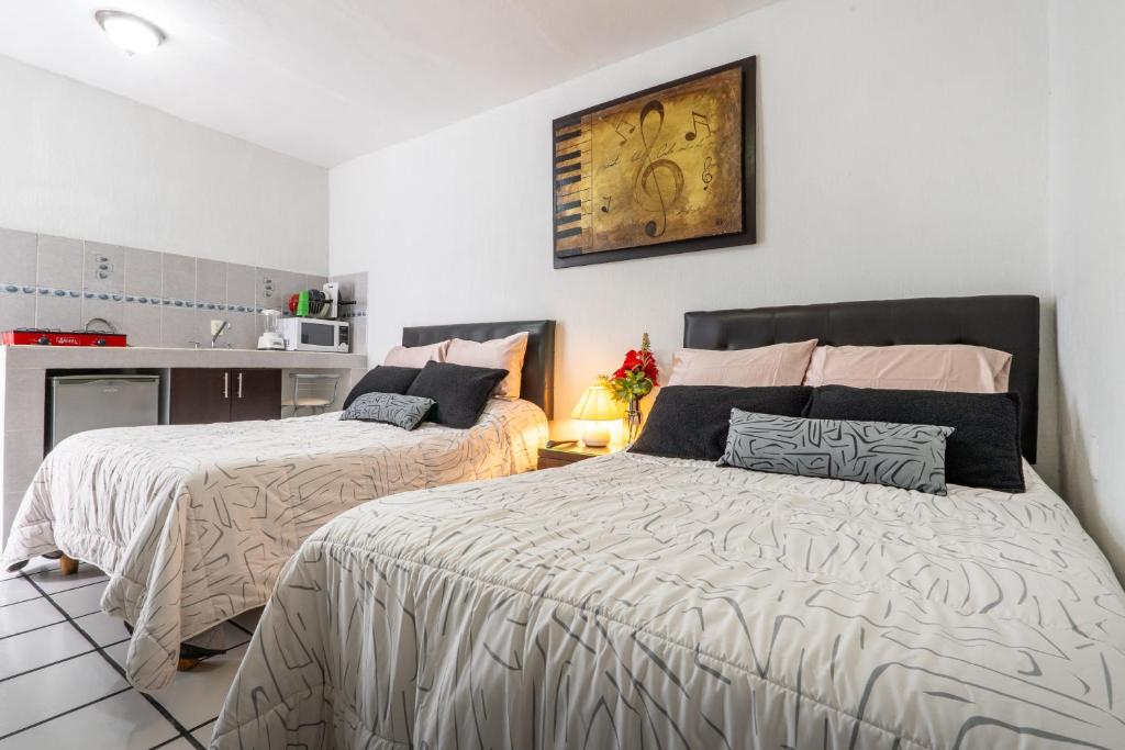 Postel nebo postele na pokoji v ubytování Hotel Bugambilias Poliforum