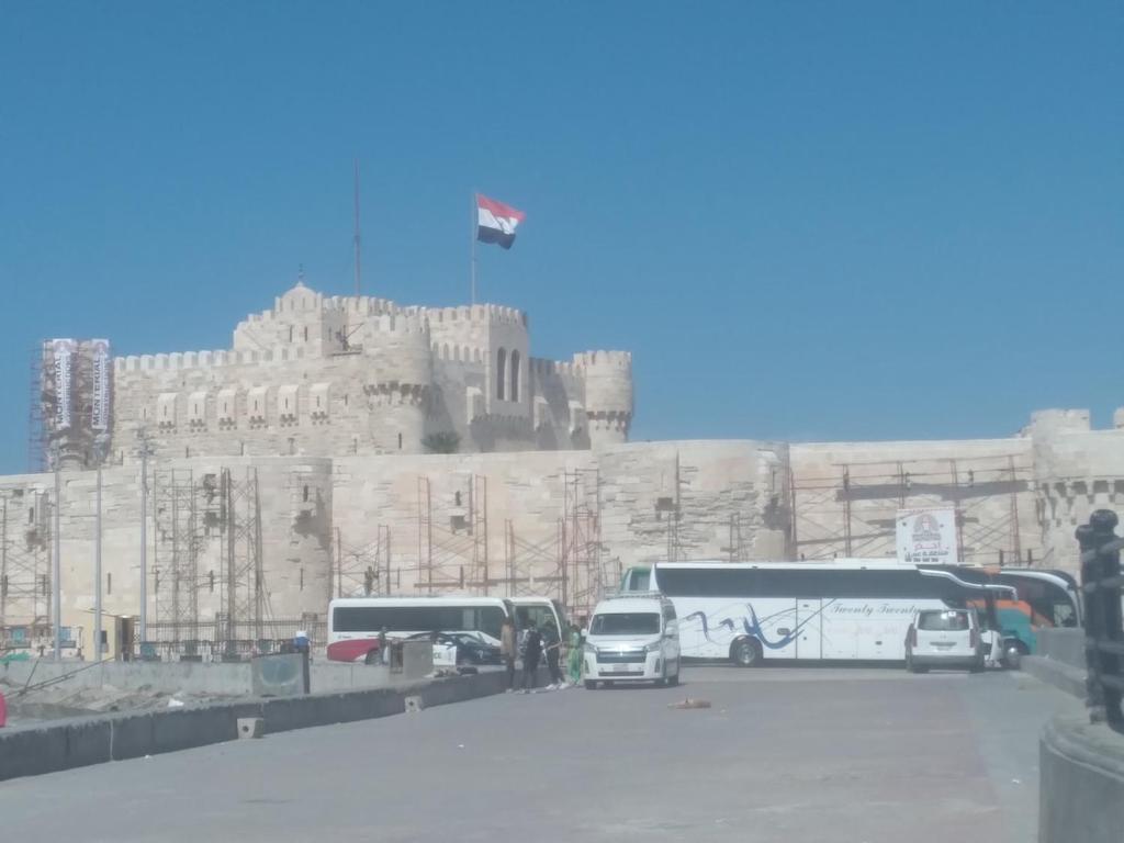 a group of buses parked in front of a castle at Affordable downtown studio steps to sea free wifi in Alexandria
