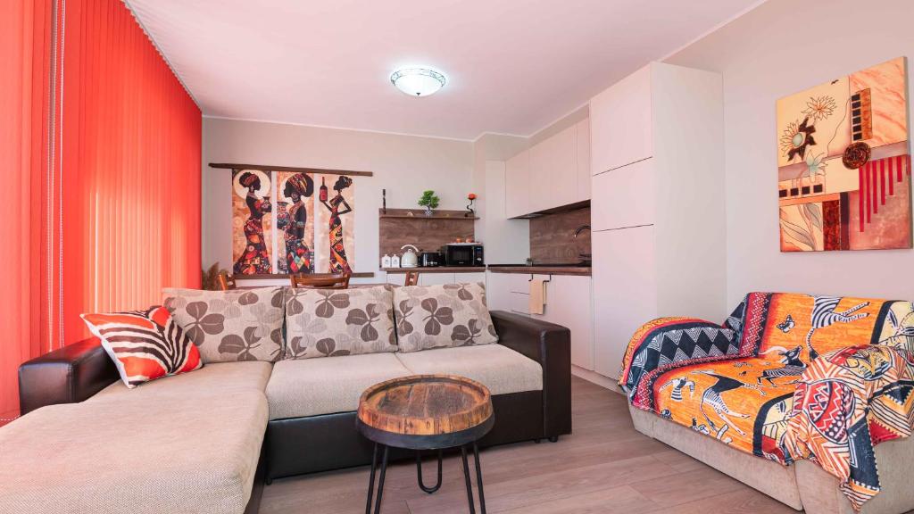 a living room with a couch and a chair at Flat Lora Pomorie in Pomorie