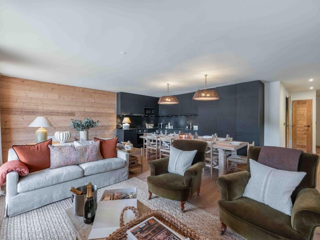un salon avec un canapé et des chaises et une cuisine dans l'établissement Appartement spacieux, ski au pied, parking inclus - FR-1-565-129, à Les Allues
