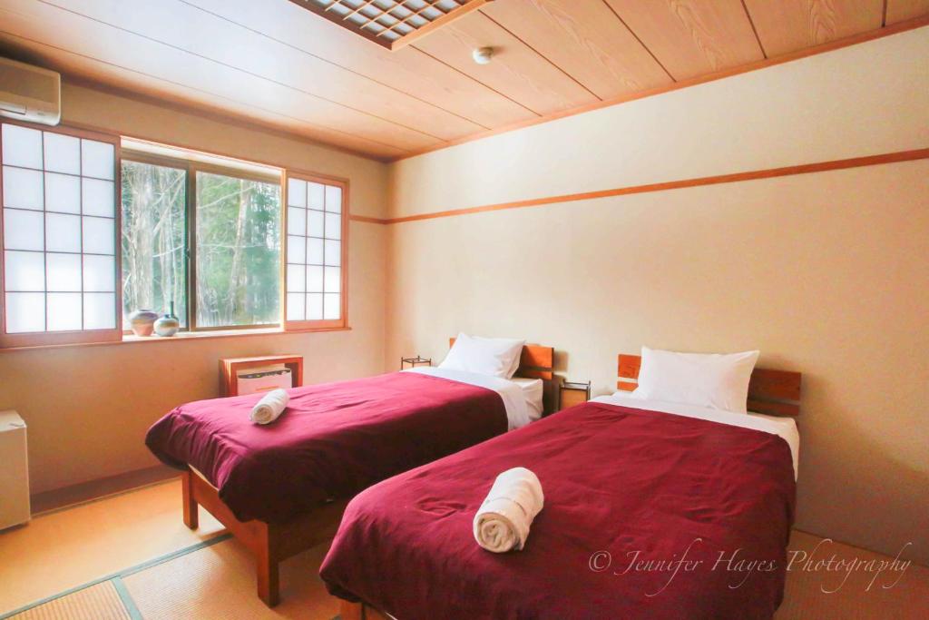 Postel nebo postele na pokoji v ubytování Morino Lodge - Hakuba