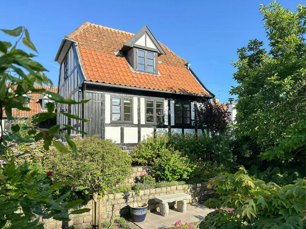 a house with a bench in front of it at Half-Timbered House With Harbor View In Ebeltoft in Ebeltoft