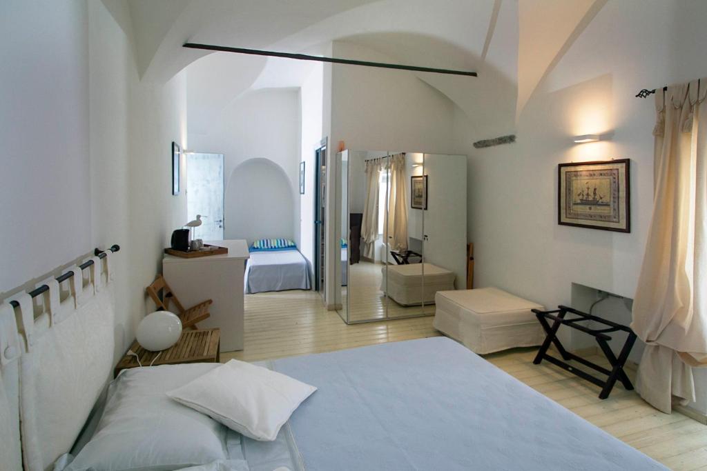 a white bedroom with a bed and a bathroom at La Casa di Alessia in Camogli