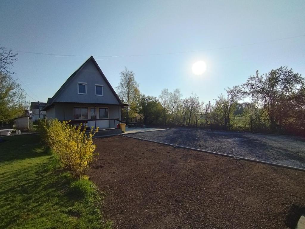 a house with a driveway in front of it at A Fogadó Vendégház in Sárospatak