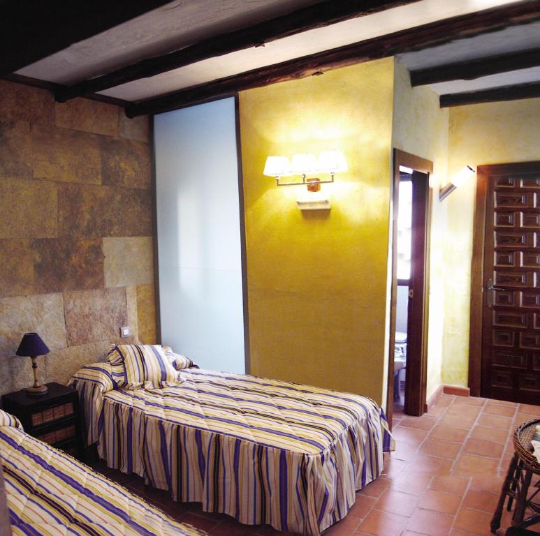 A bed or beds in a room at Casa Rural Hidalgo