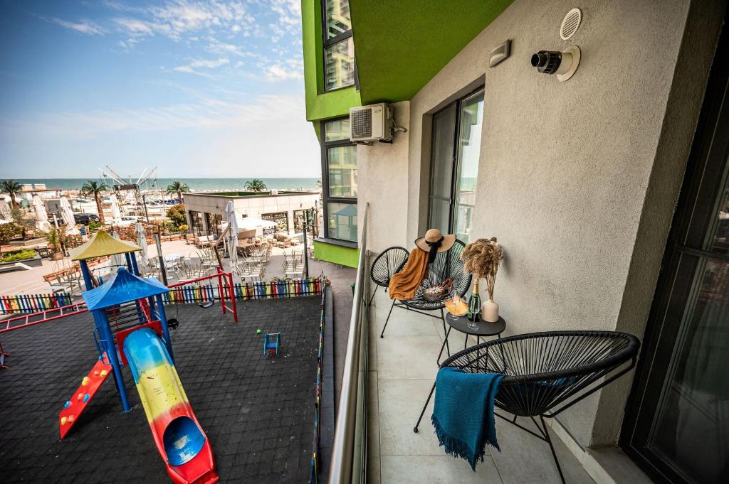 a balcony with a view of a beach at Ozone Apartment Spa & Pool Beach Resort in Mamaia
