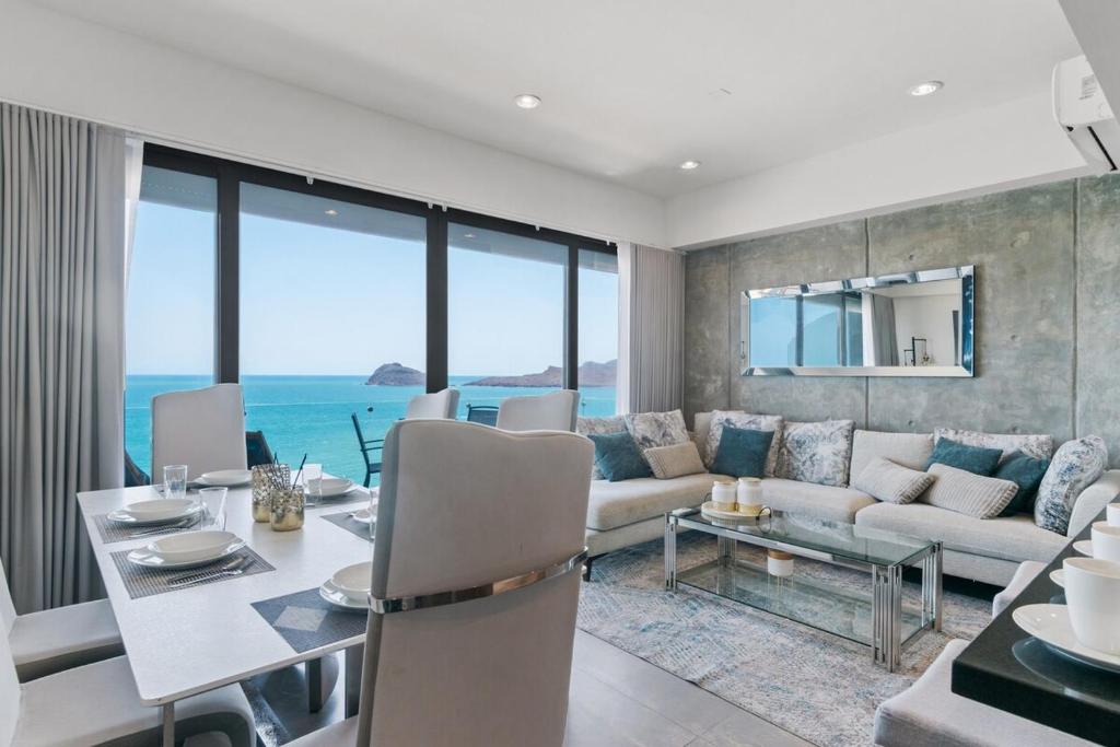 a living room with a couch and a table at Ocean View - 2 King Size with Homeoffice Space in Mazatlán