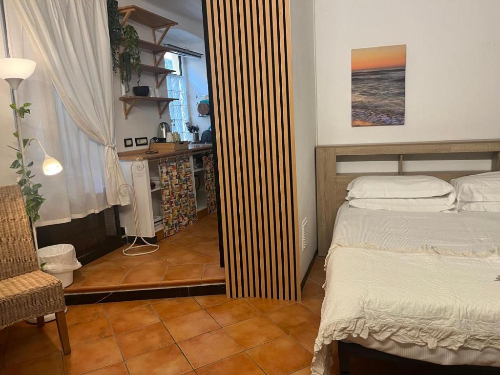 a bedroom with a bed and a room with a window at Hotel Marina in Monterosso al Mare