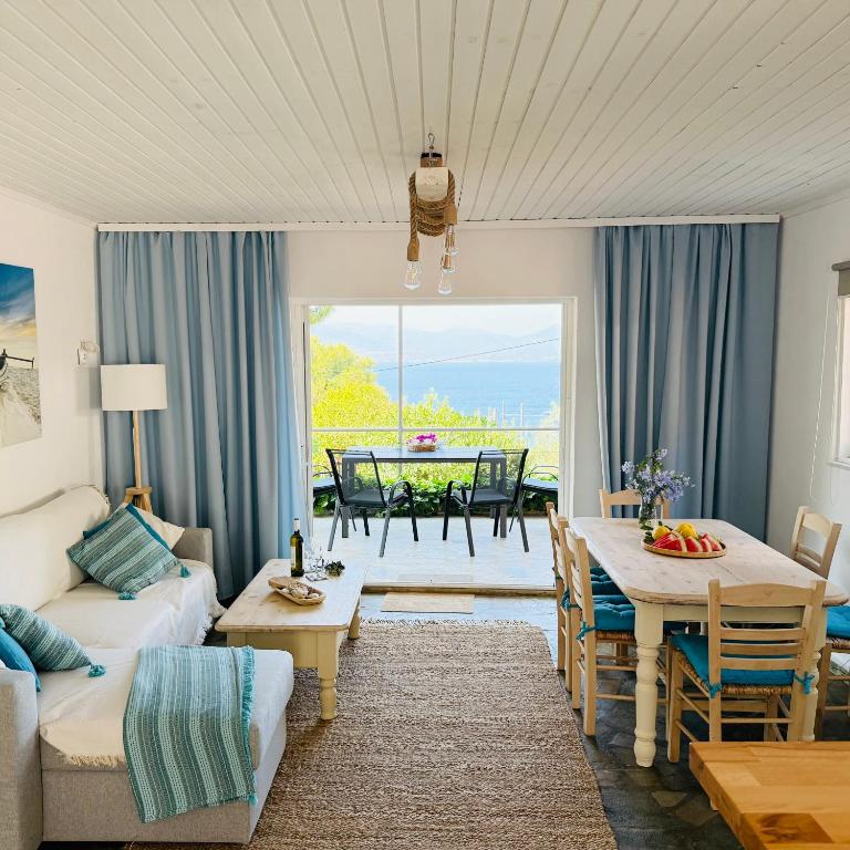 a living room with a couch and a table at Amara Blue Bay Villa in Kalamos