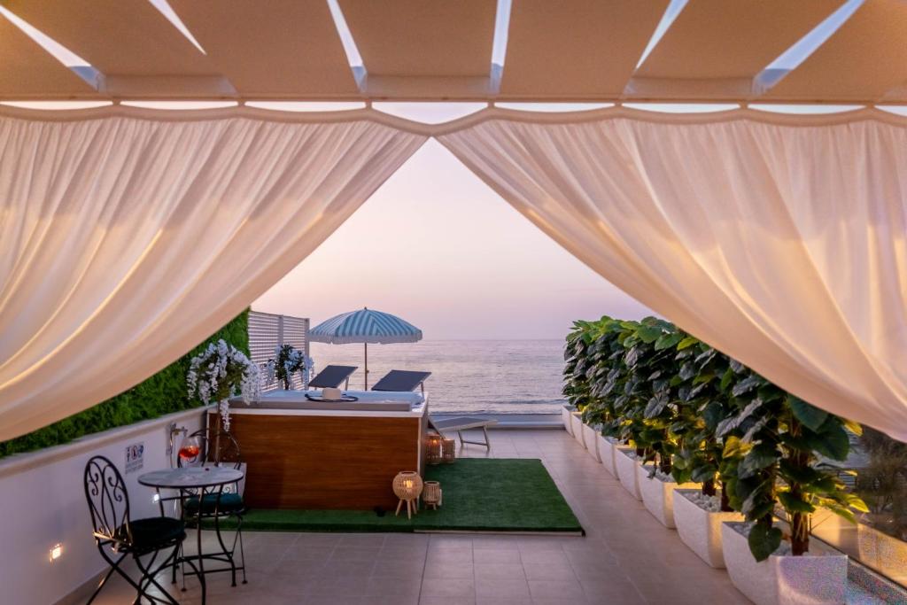 a view of the ocean from the balcony of a house at Amarè Luxury Suite And Room Vista Mare in Bari