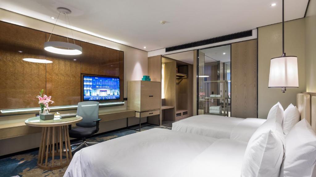 Postel nebo postele na pokoji v ubytování Zhengzhou Minghui Mandarin Hotel
