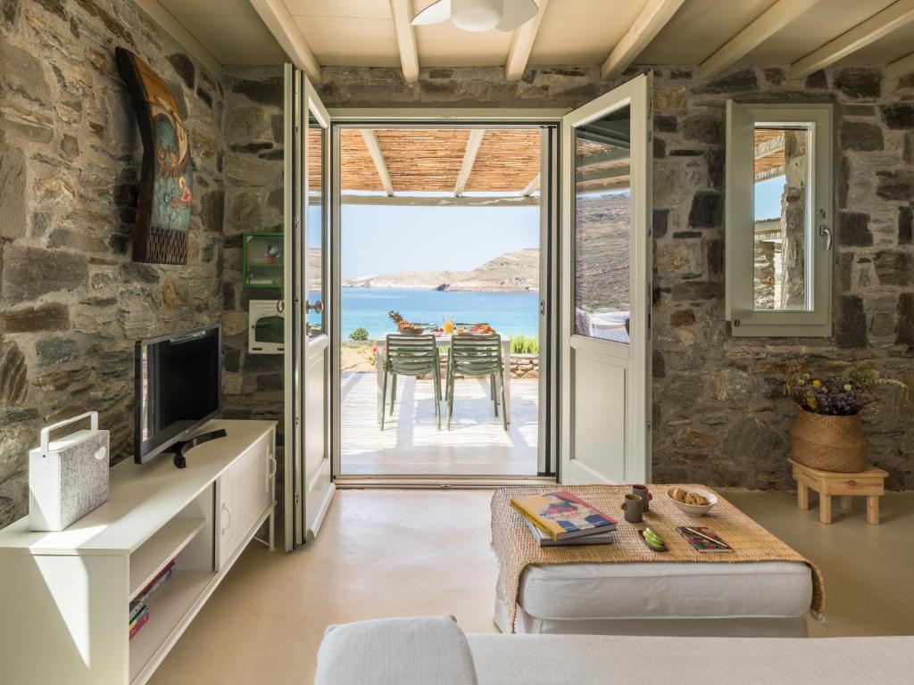 a living room with a view of the ocean at Serifos Dream Houses near the sea in Ganema