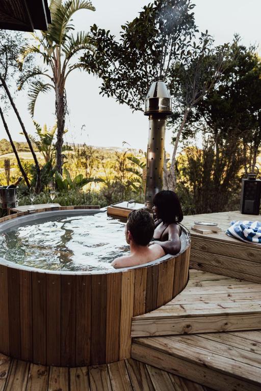 two people sitting in a jacuzzi tub at Pezula Nature Retreat in Knysna
