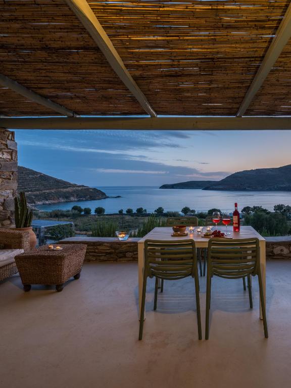 a dining room with a table and chairs with a view at Serifos Dream Houses near the sea in Ganema