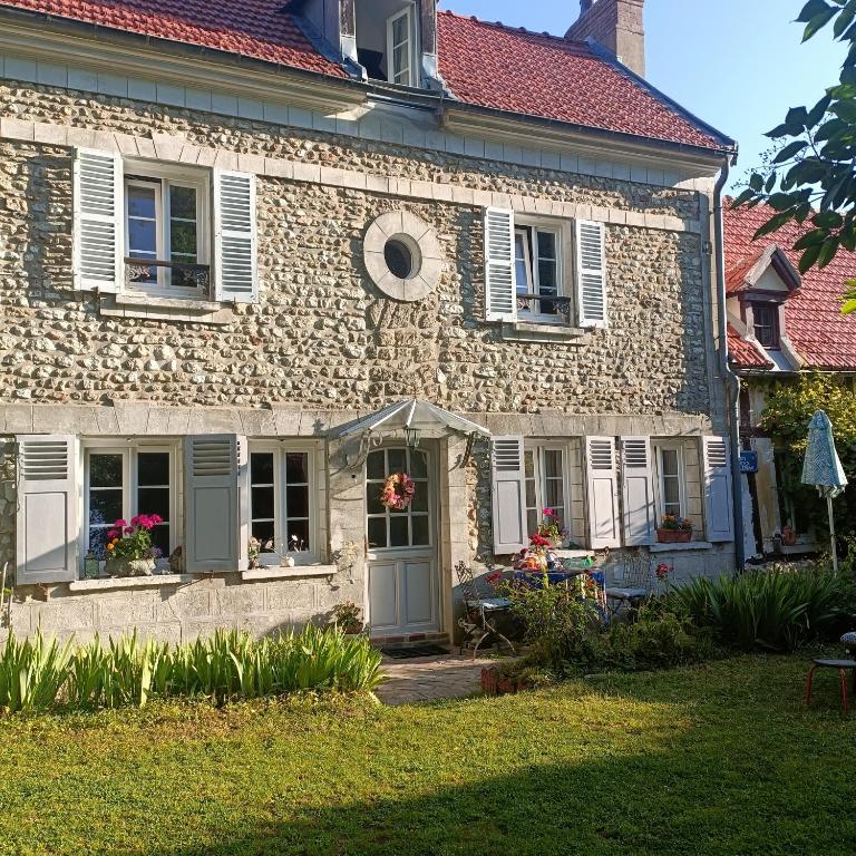 an old stone house with a garden in front of it at Avenue du Château in Saint-Just