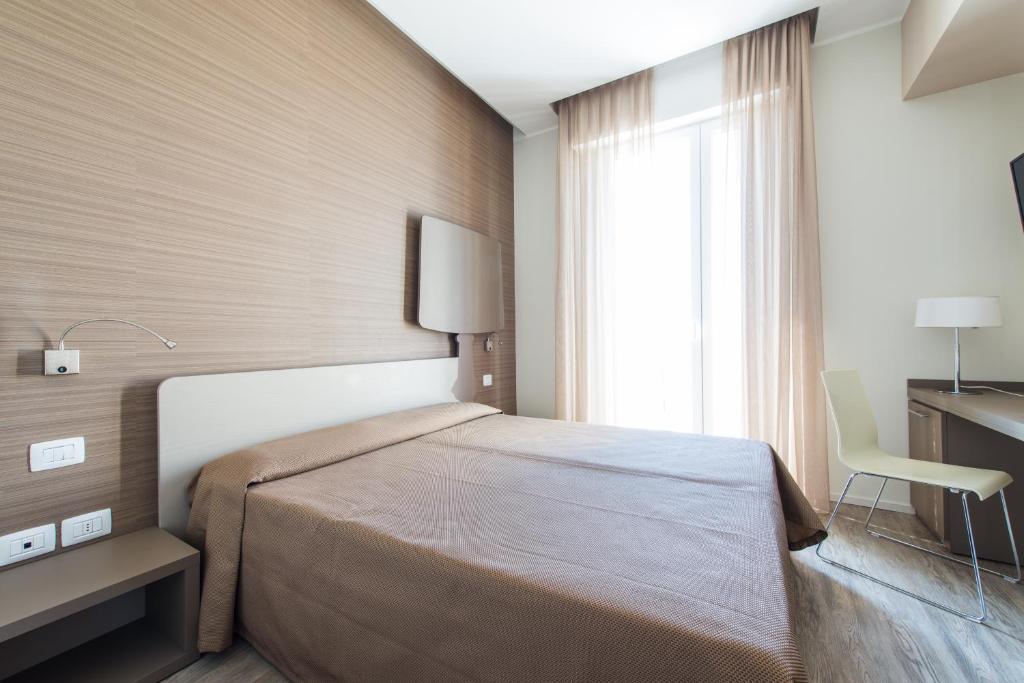 Postel nebo postele na pokoji v ubytování Hotel 2000