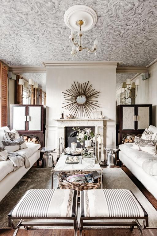a living room with a couch and a fireplace at Stylishly Designed Private Home in Central Windsor in Windsor