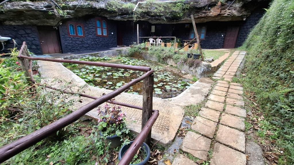 a set of stone steps leading to a house at Escape Natural Farm Stay - Cave 2 in Kanthalloor