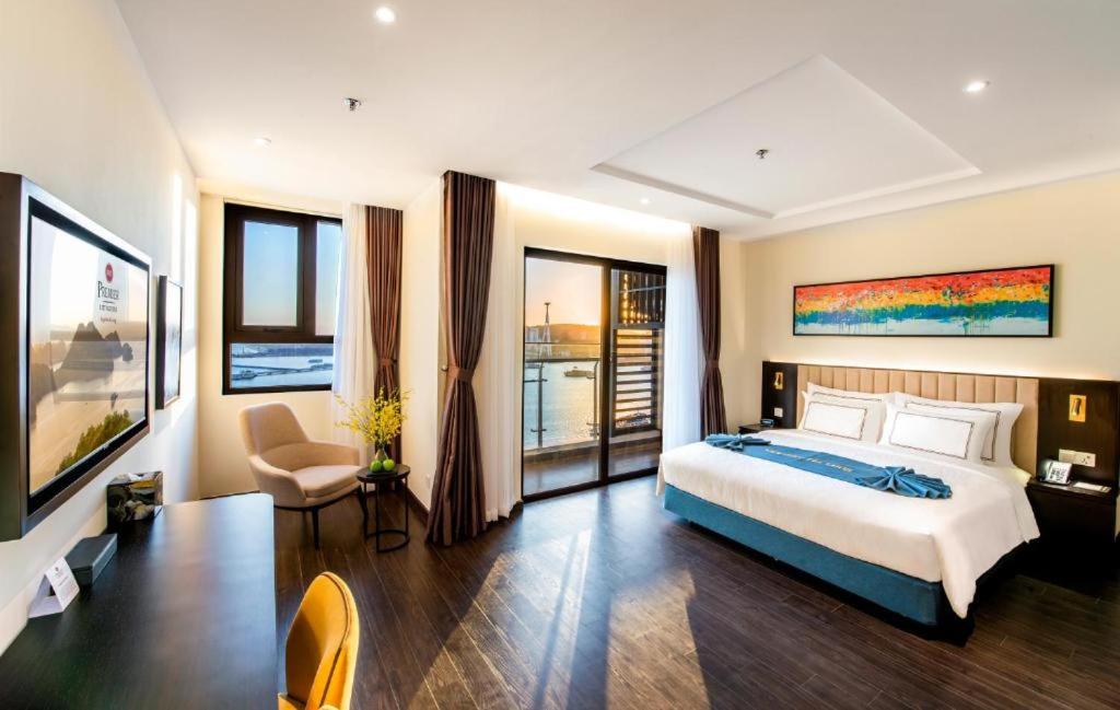 a bedroom with a large bed and a balcony at Sapphire S2 Hạ Long in Ha Long