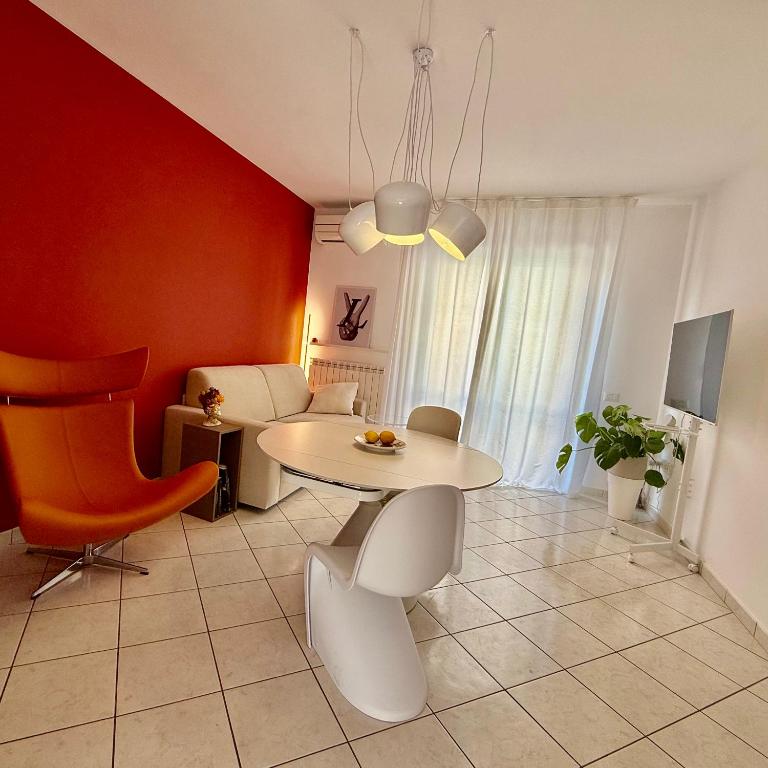 a living room with a white table and chairs at Casa SUN in Civitanova Marche