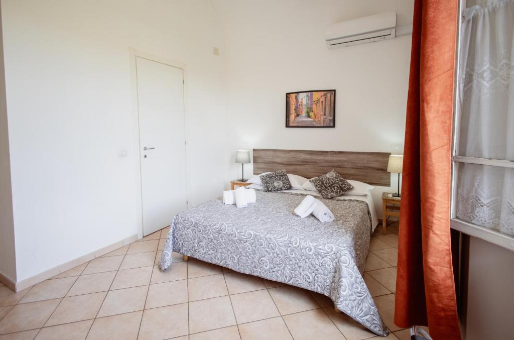 Posteľ alebo postele v izbe v ubytovaní B&B Toscana