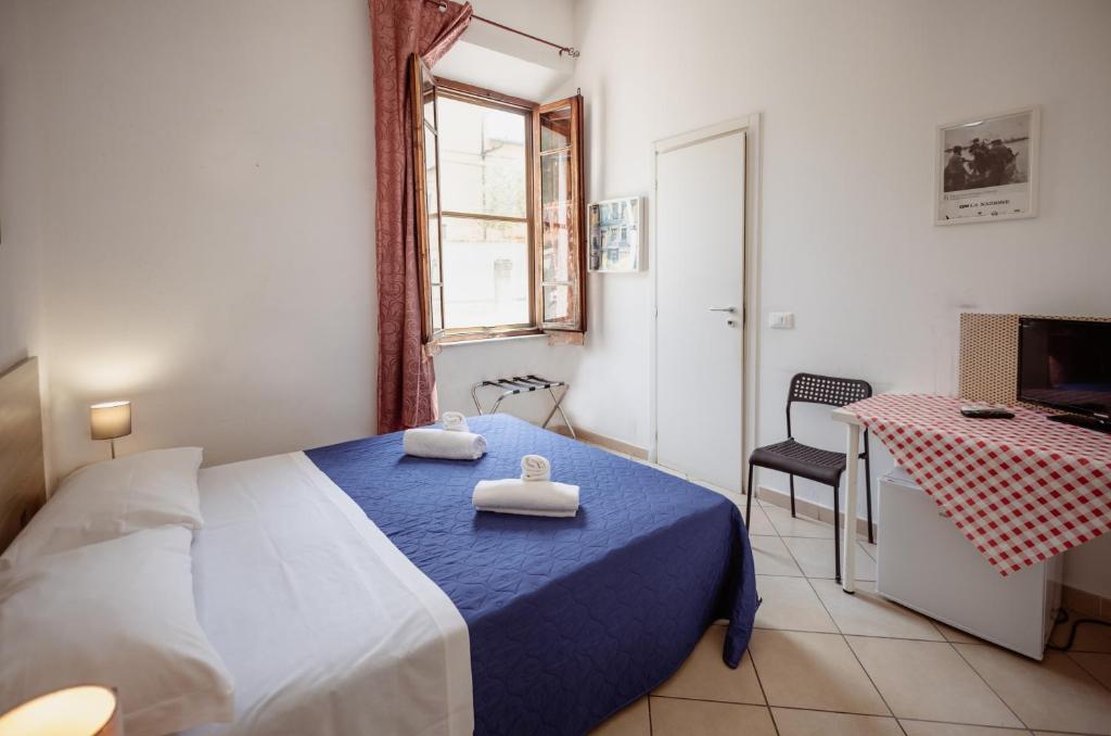 Posteľ alebo postele v izbe v ubytovaní B&B Toscana