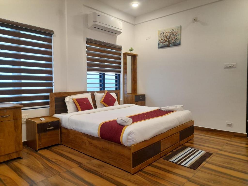 a bedroom with a bed and a window at VGK Residency in Wayanad