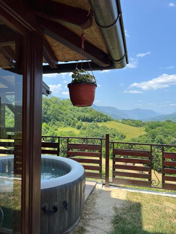 a hot tub on a patio with a view at Apartman Sofiana in Bajina Bašta