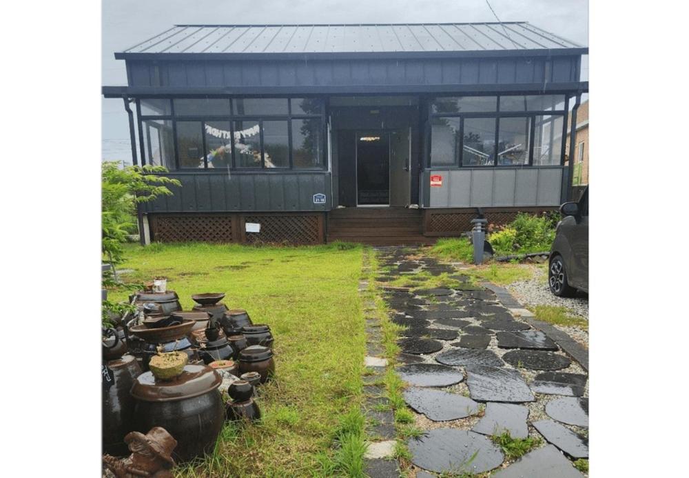 a house with a bunch of pots and pans at Buyeo Eoksae Jeongwon Pension in Buyeo