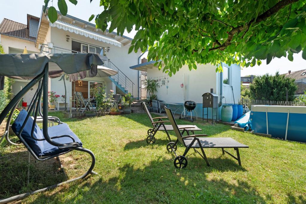 a yard with two chairs and a swing at Appartement Sonnenschein in Berghausen