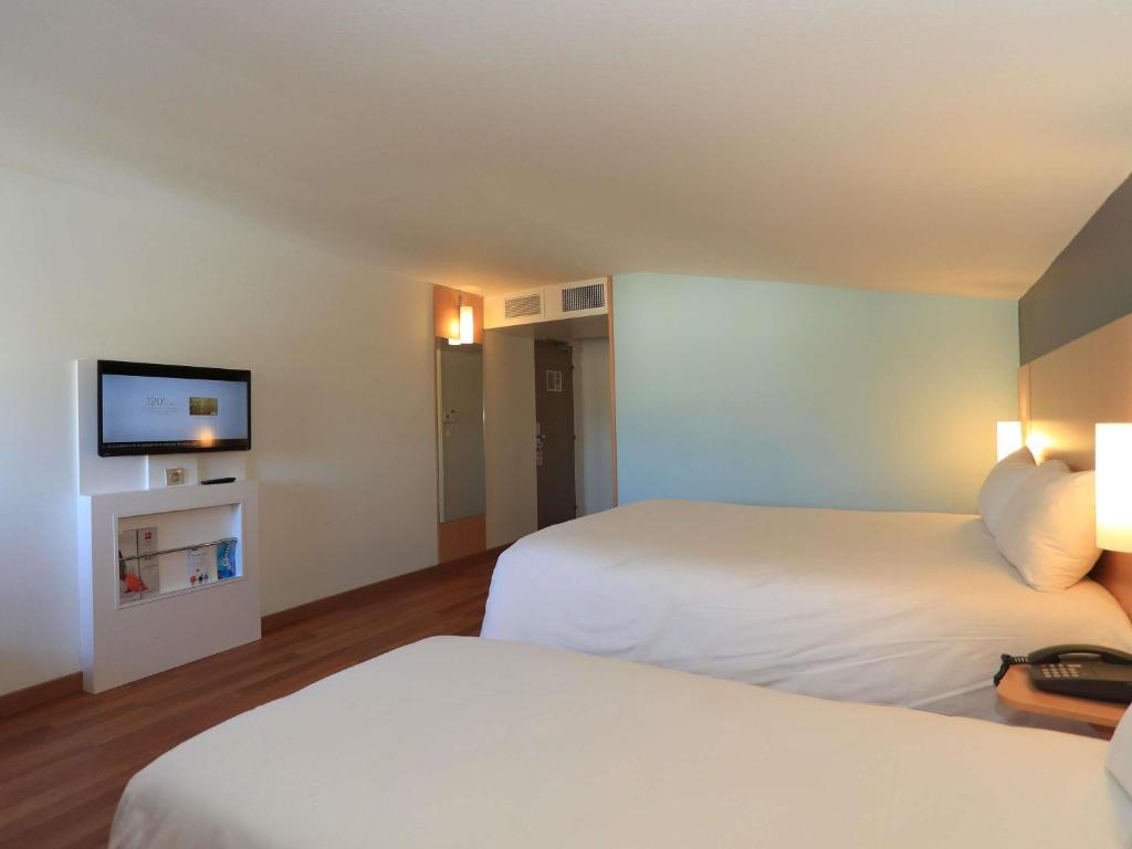 Postel nebo postele na pokoji v ubytování ibis Aurillac