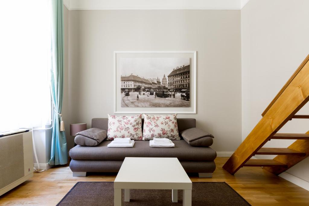 a living room with a couch and a table at Lisianthus Apartments in Budapest