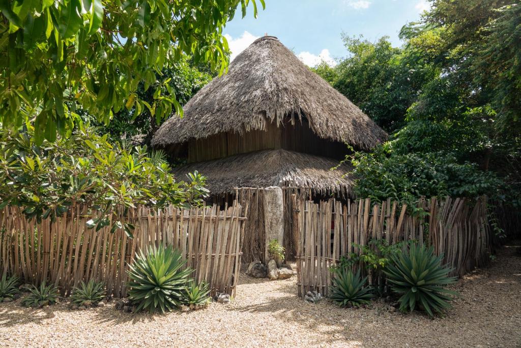 a small hut with a fence in front of it at Boa Gardens Boutique Guesthouse Rote in Pulau Helihana